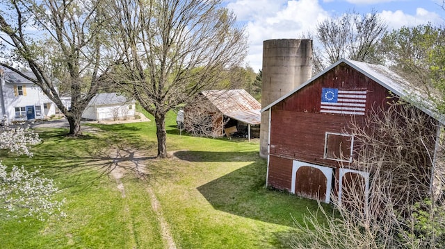 view of yard featuring a barn and an outdoor structure