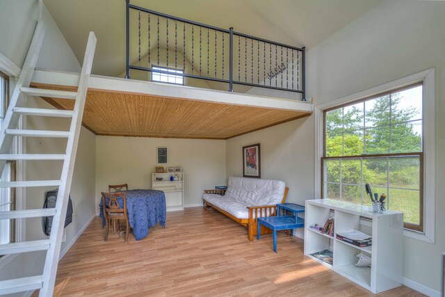 living area featuring a healthy amount of sunlight, baseboards, and wood finished floors