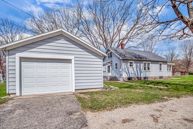 detached garage featuring driveway