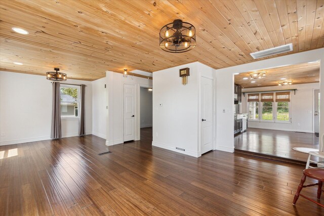 unfurnished living room with visible vents, wood ceiling, plenty of natural light, and a notable chandelier
