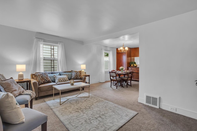 1319 Rhodes St, Jackson, MI 49202 - living room with a chandelier, healthy amount of natural light, light colored carpet, and baseboards