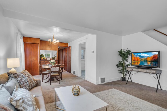 1319 Rhodes St, Jackson, MI 49202 - living room featuring carpet, a chandelier, and baseboards