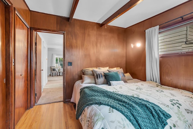 1319 Rhodes St, Jackson, MI 49202 - bedroom featuring light wood-type flooring, beamed ceiling, and wood walls