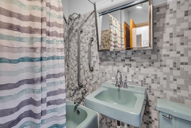 1319 Rhodes St, Jackson, MI 49202 - bathroom with tile walls, a sink, and shower / bathtub combination with curtain