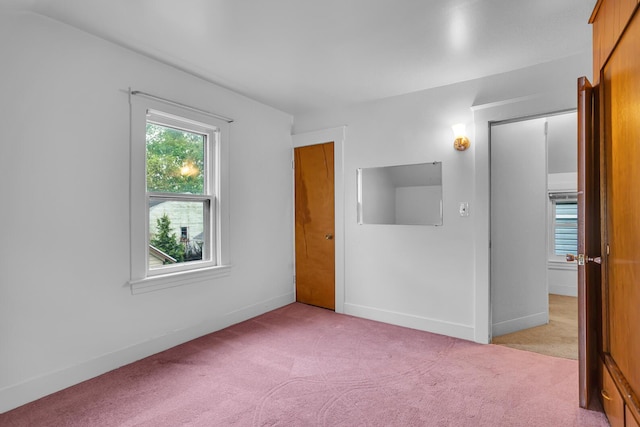 1319 Rhodes St, Jackson, MI 49202 - unfurnished bedroom with light carpet and baseboards