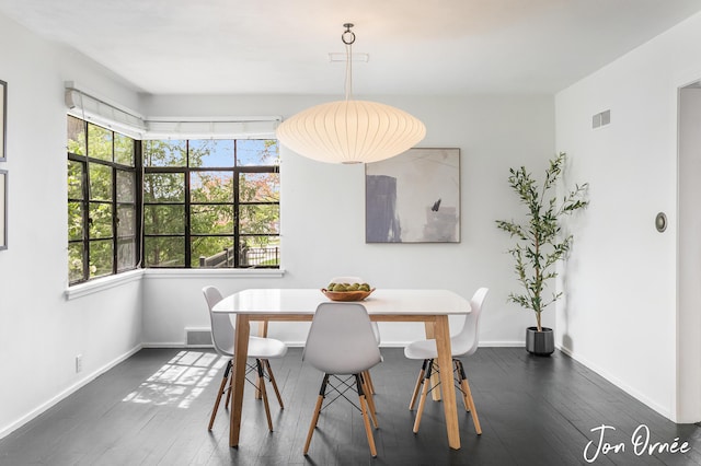 dining room with a wealth of natural light, dark wood-type flooring, and visible vents