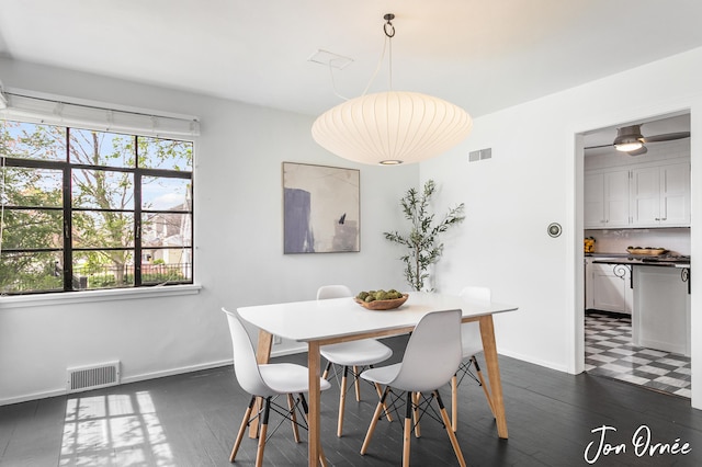 dining area with baseboards, dark wood-style flooring, and visible vents