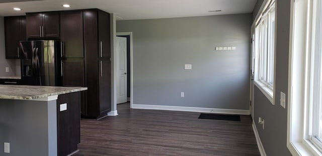 kitchen featuring black refrigerator with ice dispenser, dark brown cabinetry, baseboards, dark wood-type flooring, and recessed lighting