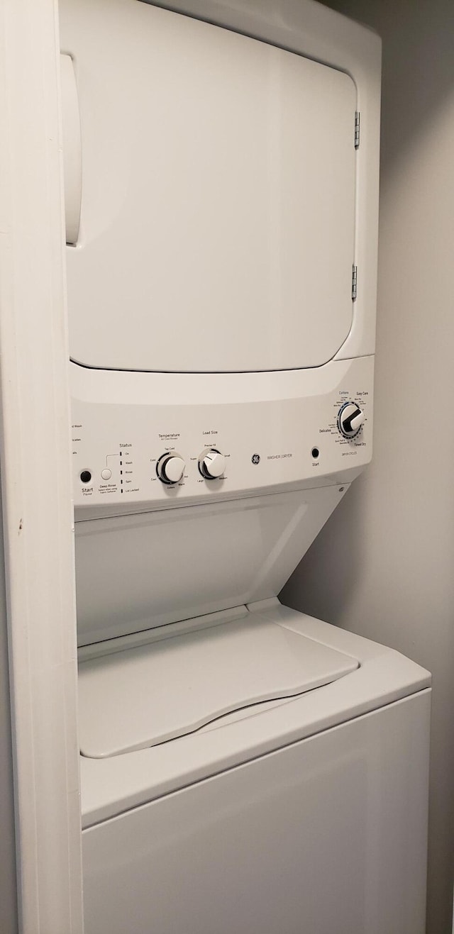washroom with laundry area and stacked washer / drying machine