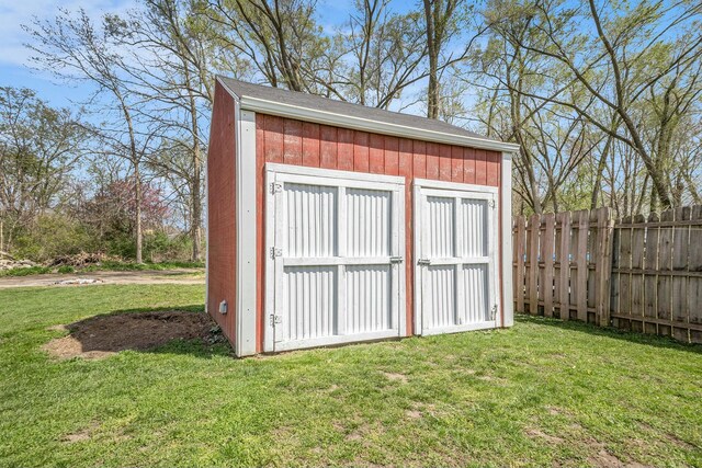 view of shed featuring fence