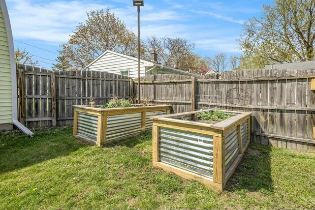 view of yard with fence and a vegetable garden