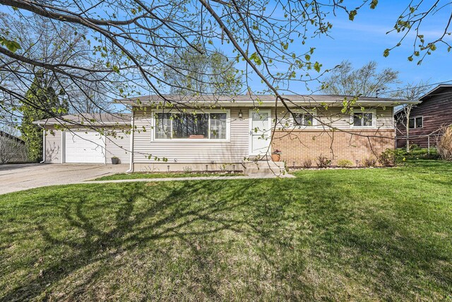 ranch-style home featuring a garage, driveway, and a front yard