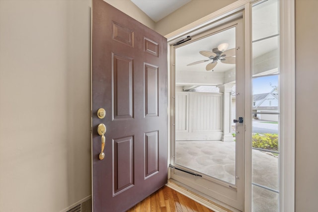doorway featuring ceiling fan and light wood-style floors