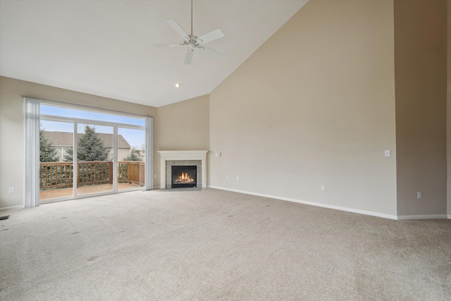 unfurnished living room featuring carpet flooring, baseboards, high vaulted ceiling, ceiling fan, and a fireplace