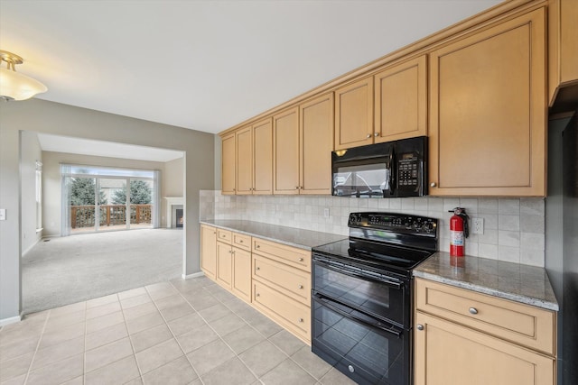 kitchen featuring black appliances, light carpet, backsplash, and baseboards