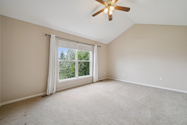 unfurnished room with a ceiling fan, lofted ceiling, carpet floors, and baseboards