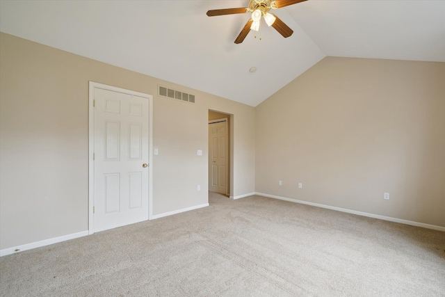 unfurnished bedroom with vaulted ceiling, light carpet, baseboards, and a ceiling fan