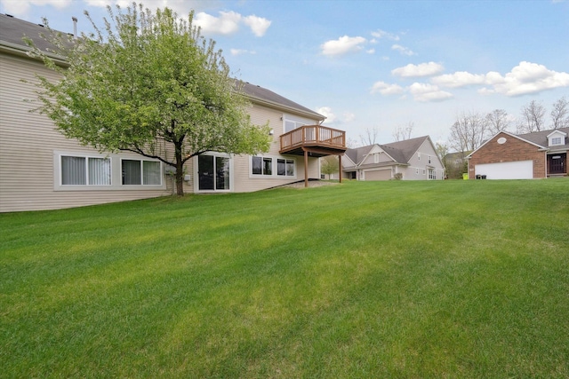 view of green lawn featuring a wooden deck and a residential view
