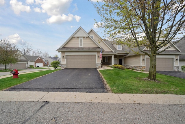 view of front of house with stone siding, driveway, and a front yard