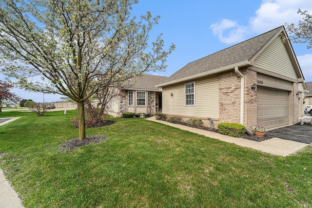 ranch-style house with roof with shingles, an attached garage, brick siding, driveway, and a front lawn