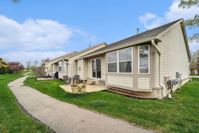 back of house with a yard and a patio area