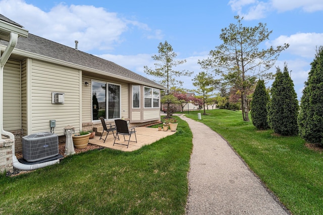 view of yard featuring central AC unit and a patio