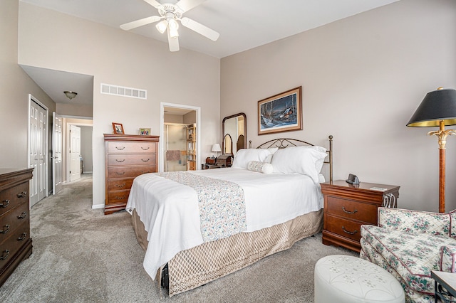 bedroom featuring vaulted ceiling, carpet, visible vents, and a ceiling fan