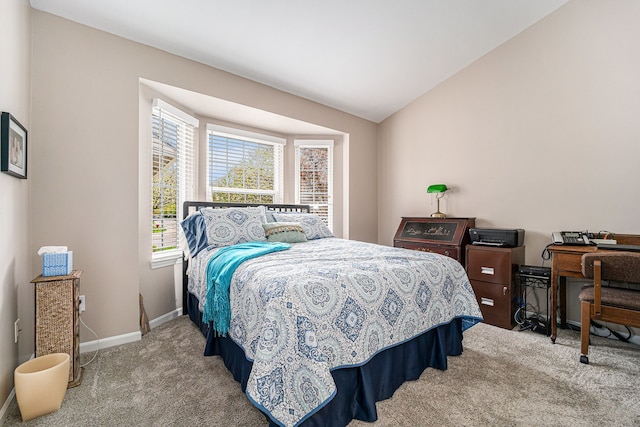 bedroom with baseboards, carpet, and vaulted ceiling