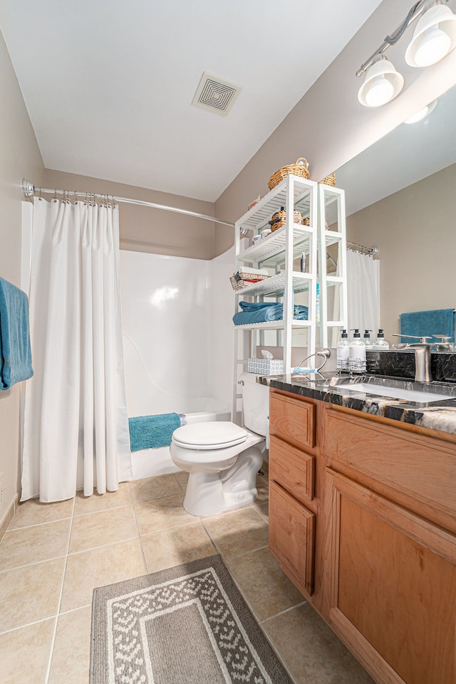 bathroom featuring toilet, tile patterned floors, vanity, and visible vents