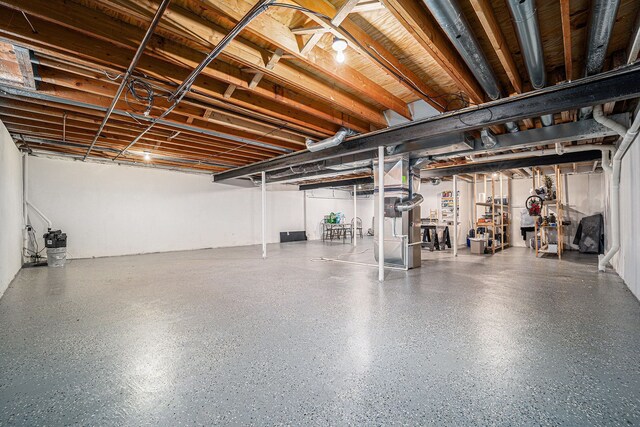 unfinished basement featuring heating unit