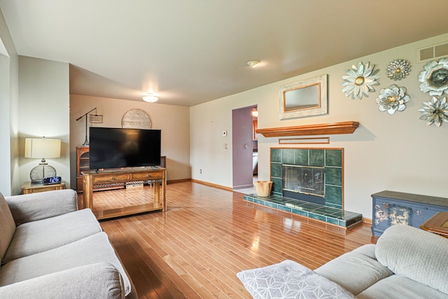 20425 Villa Grande Cir Unit # 31, Clinton Township, MI 48038 - living room with baseboards, visible vents, a tiled fireplace, and hardwood / wood-style floors