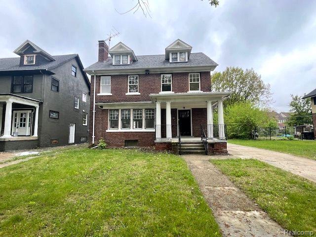 1485 Longfellow St, Detroit, MI 48206 - american foursquare style home featuring a porch, brick siding, a front lawn, and a chimney