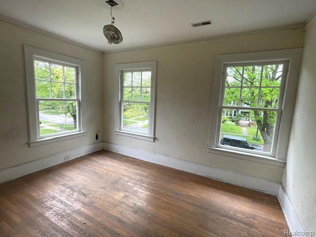 1485 Longfellow St, Detroit, MI 48206 - unfurnished room with wood-type flooring, baseboards, and ornamental molding
