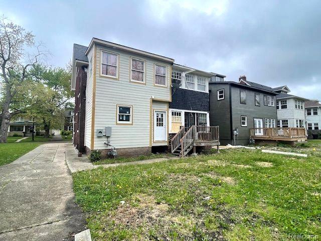 1485 Longfellow St, Detroit, MI 48206 - back of house featuring a wooden deck and a lawn