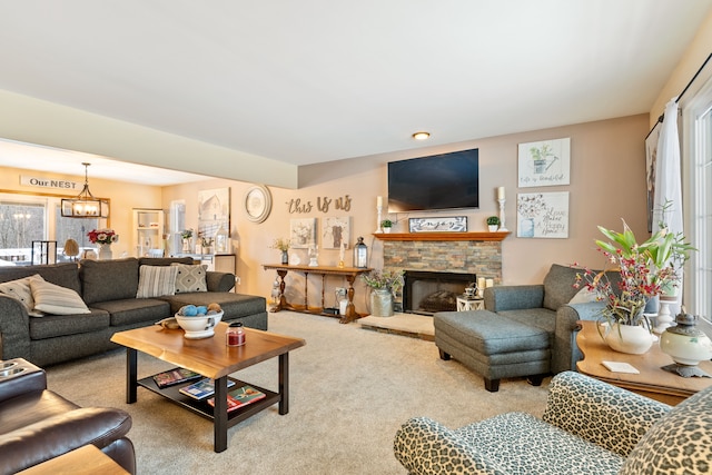 carpeted living room with a chandelier and a fireplace