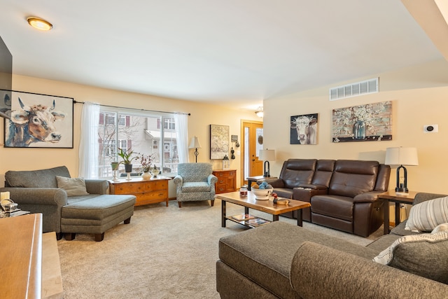 living area featuring light carpet and visible vents