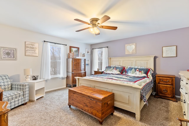bedroom with light colored carpet, baseboards, and ceiling fan