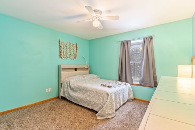 carpeted bedroom featuring baseboards and a ceiling fan