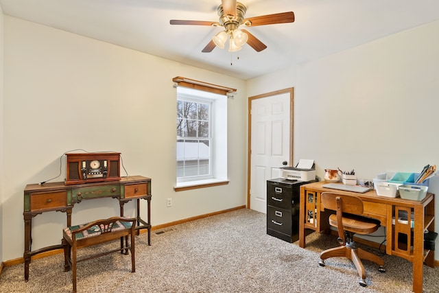 office space featuring carpet floors, ceiling fan, visible vents, and baseboards