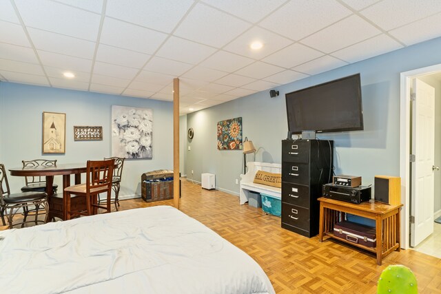 bedroom featuring baseboards, a drop ceiling, and recessed lighting