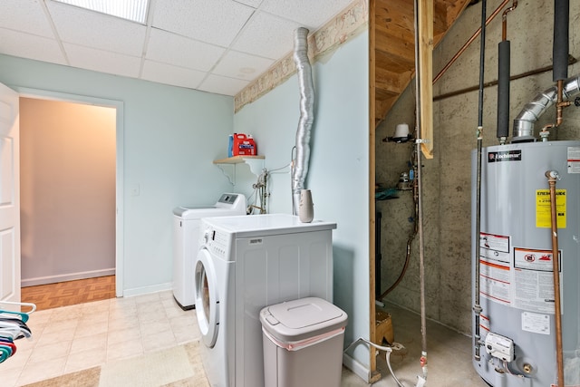 laundry area featuring washer and dryer, laundry area, water heater, baseboards, and visible vents