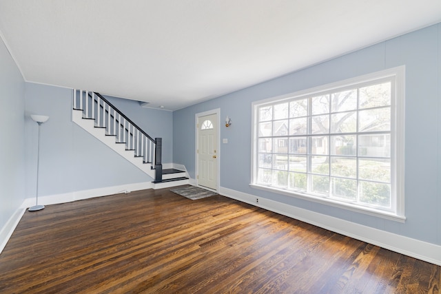 entryway featuring baseboards, stairs, and dark wood-style flooring
