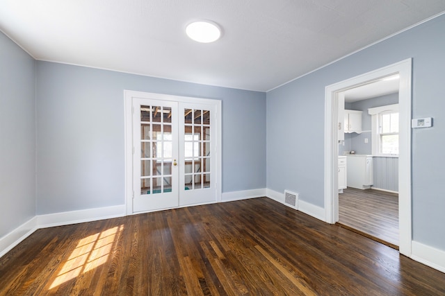 interior space with baseboards, french doors, visible vents, and wood finished floors