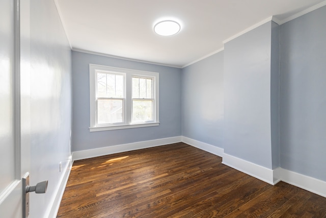 unfurnished room with baseboards, ornamental molding, and dark wood finished floors