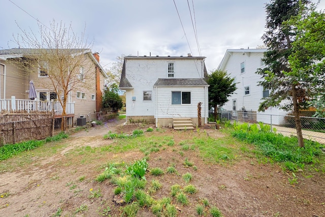 rear view of property with fence and cooling unit