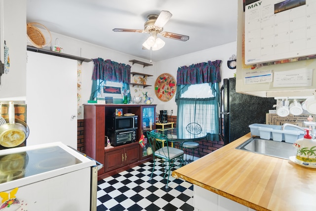 11718 Wayburn St, Detroit, MI 48224 - kitchen featuring tile patterned floors, a sink, a ceiling fan, electric stove, and stainless steel microwave