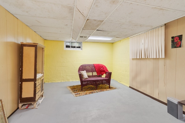 11718 Wayburn St, Detroit, MI 48224 - living area with wooden walls and concrete floors