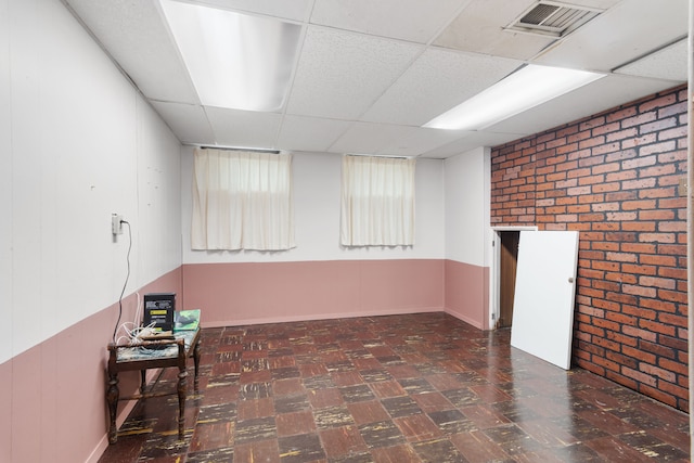 11718 Wayburn St, Detroit, MI 48224 - finished below grade area with a paneled ceiling, tile patterned floors, and brick wall