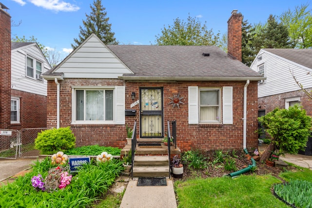 11718 Wayburn St, Detroit, MI 48224 - bungalow-style house featuring brick siding, a chimney, and roof with shingles