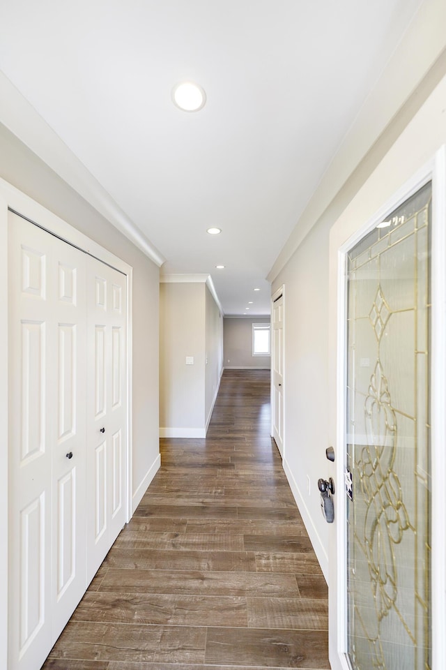 hallway featuring baseboards, ornamental molding, recessed lighting, and dark wood-type flooring